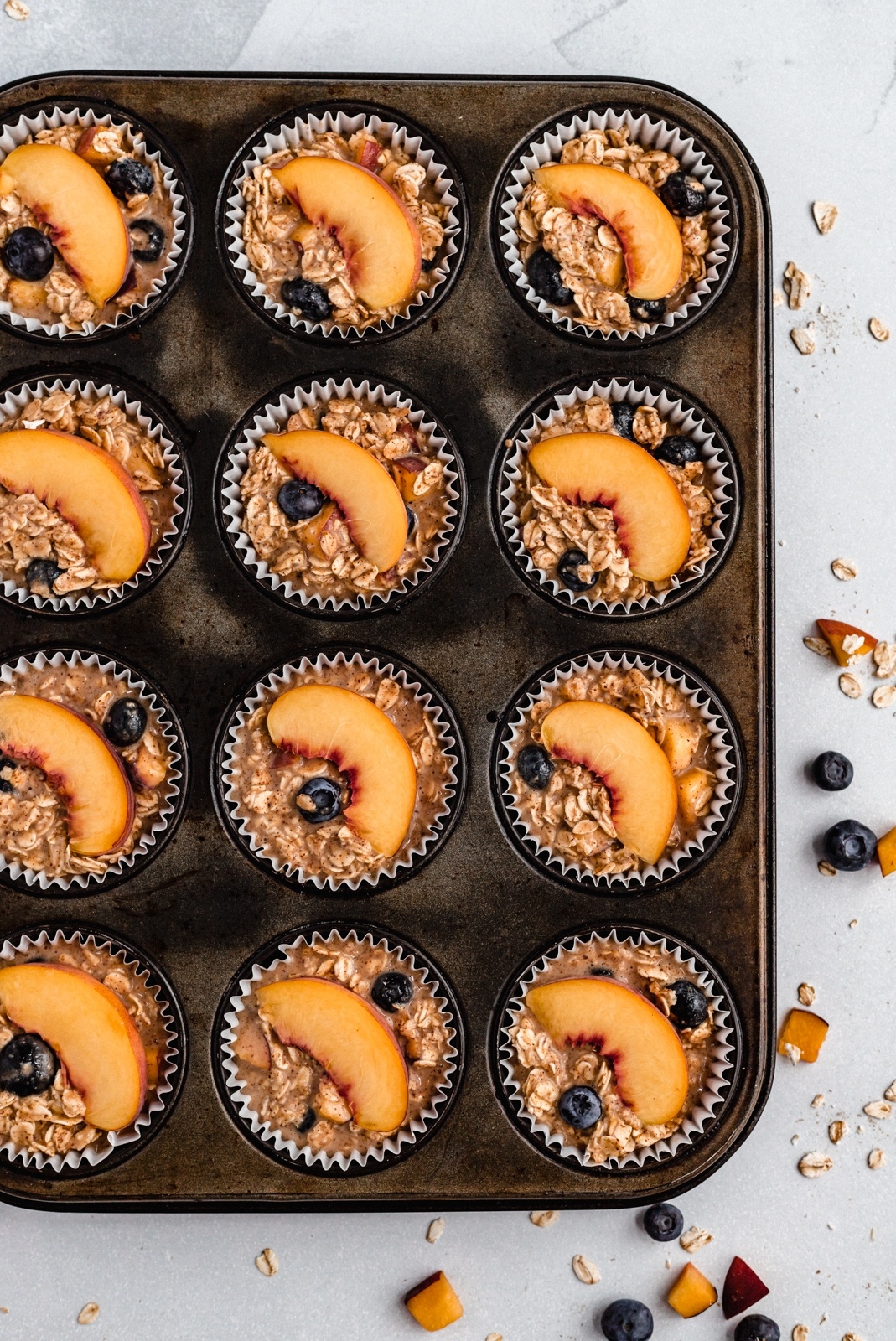 almond butter peach oatmeal cups in a muffin tin